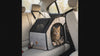 Cat riding securely in the Vista car-seat carrier, looking out the mesh door